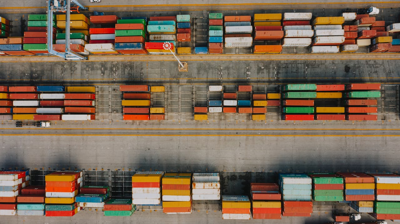 gallery-2 Drone view of various colorful cargo containers placed in rows on asphalt in daytime